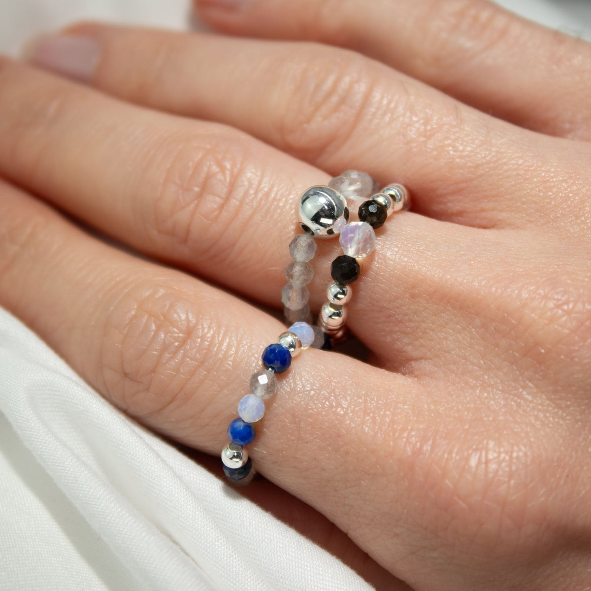 Mystical Nymph Spirit Gemstone 3-Ring Set – Northern Lights draped across fingers with blue, grey and silver-tone beads by Quintessential Holistic Health Ltd