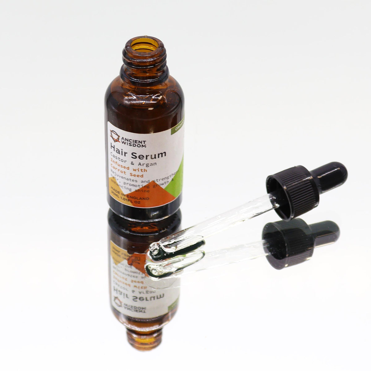Organic Vegan-Friendly Carrot Seed Hair Serum - 30ml, showing an open brown bottle with two glass droppers alongside, by Quintessential Holistic Health Ltd