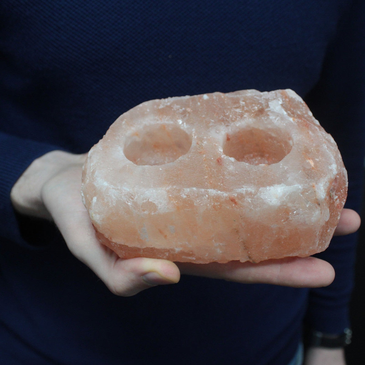 Himalayan Salt Crystal Candle Holder - Natural Rectangular Double held in one hand with two empty circular recesses by Quintessential Holistic Health Ltd