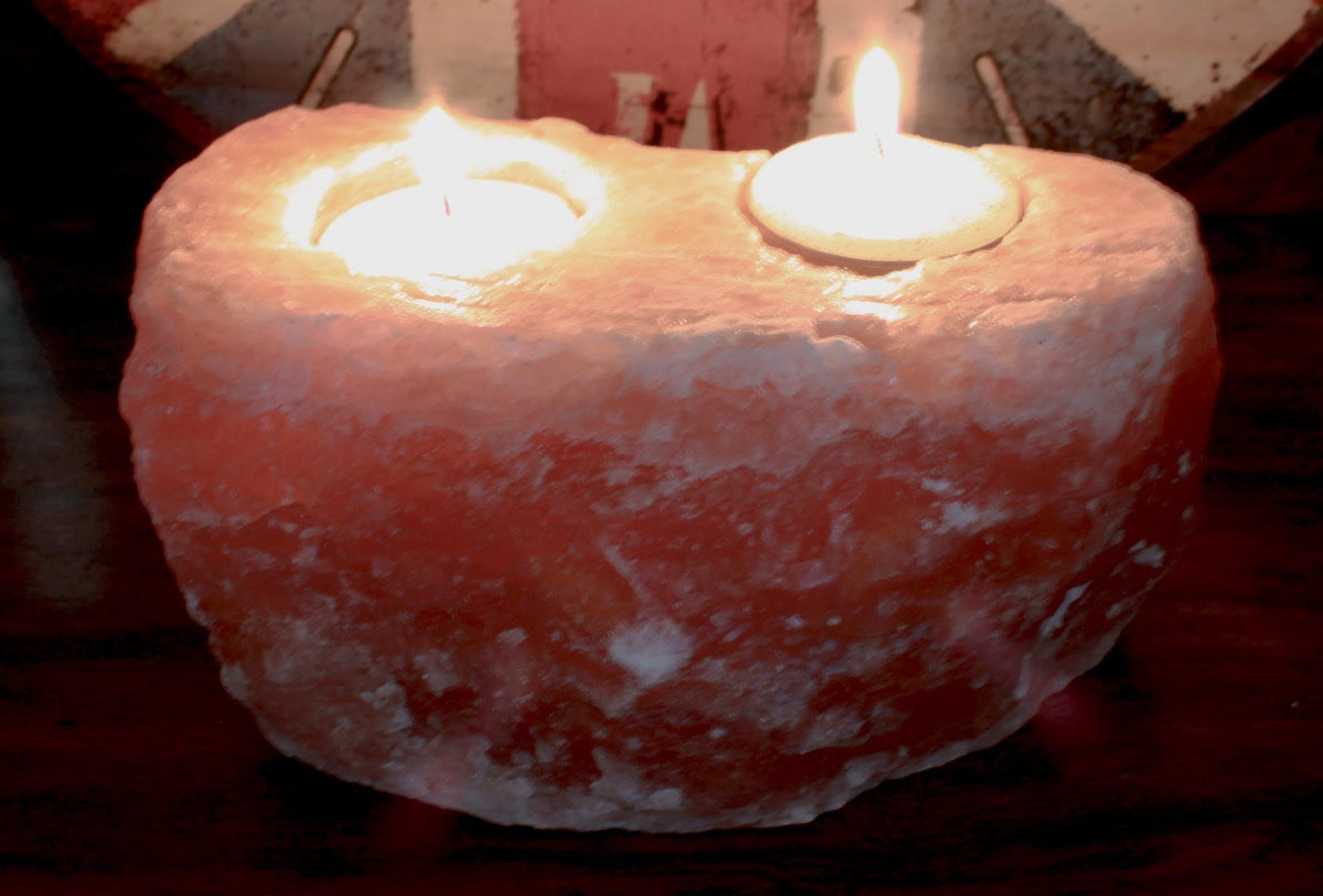 Himalayan Salt Crystal Candle Holder - Natural Rectangular Double with two lit candles in a rough pink block by Quintessential Holistic Health Ltd