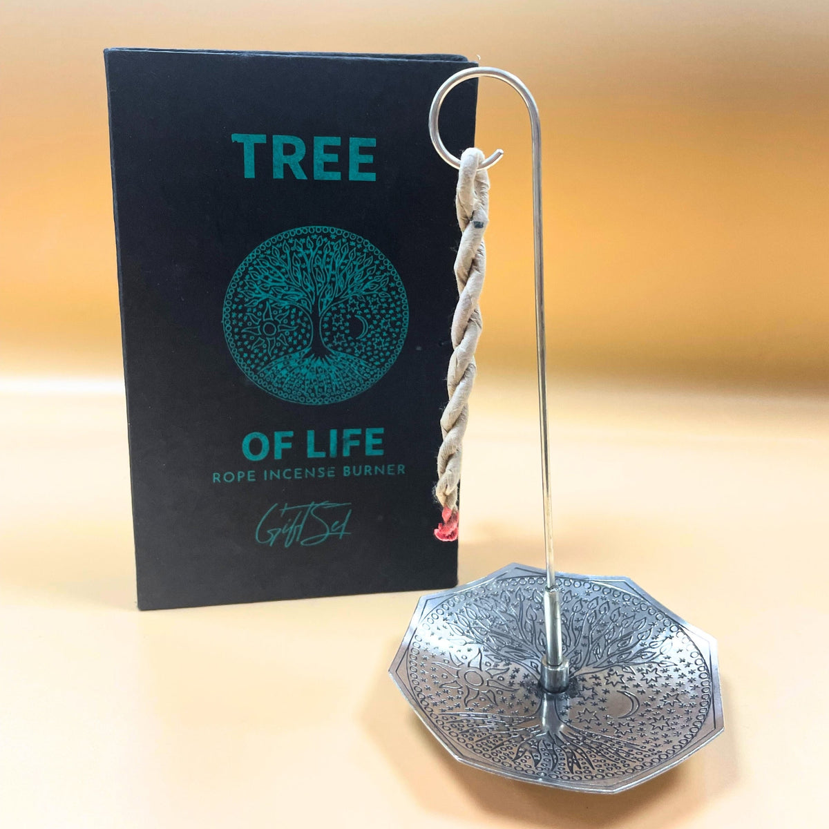 Rope Incense and Silver Plated Holder Set - Tree of Life, octagonal holder and hanging twisted rope beside black cover, by Quintessential Holistic Health Ltd