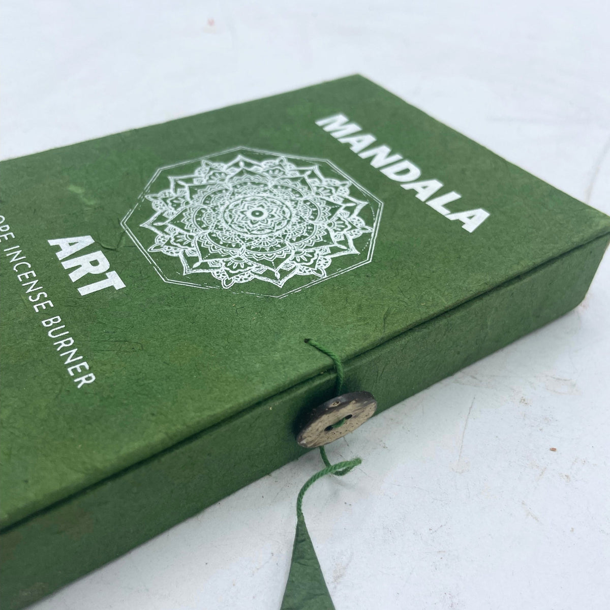 Rope Incense and Silver Plated Holder Set - Mandala Flower with white motif, lettering and button tie on a green cover by Quintessential Holistic Health Ltd