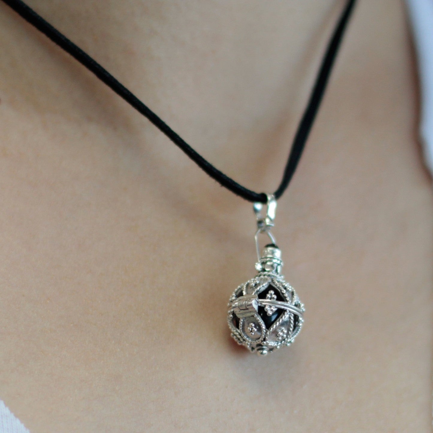 Handmade 925 Silver Angel Bell Pendant Necklace - 16mm / Darkness product packaging on clean background from Quintessential Holistic Health Ltd