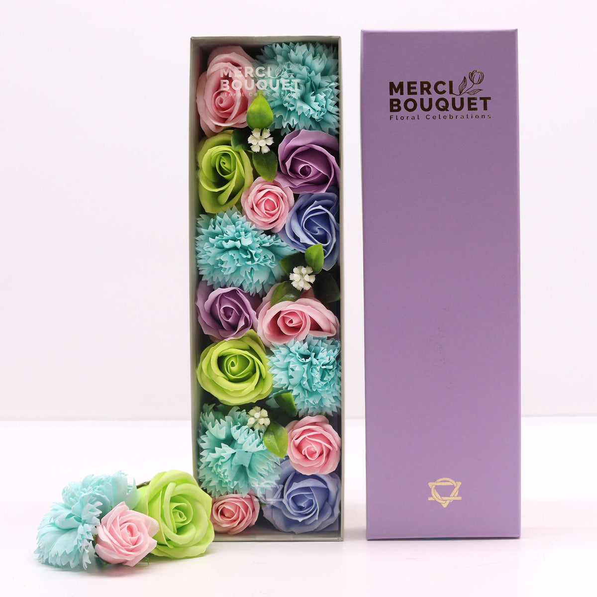 Luxury Soap Flowers - Long - Blues with rows of blue, pink, green and purple flowers beside a tall purple lid and loose blooms by Quintessential Holistic Health Ltd