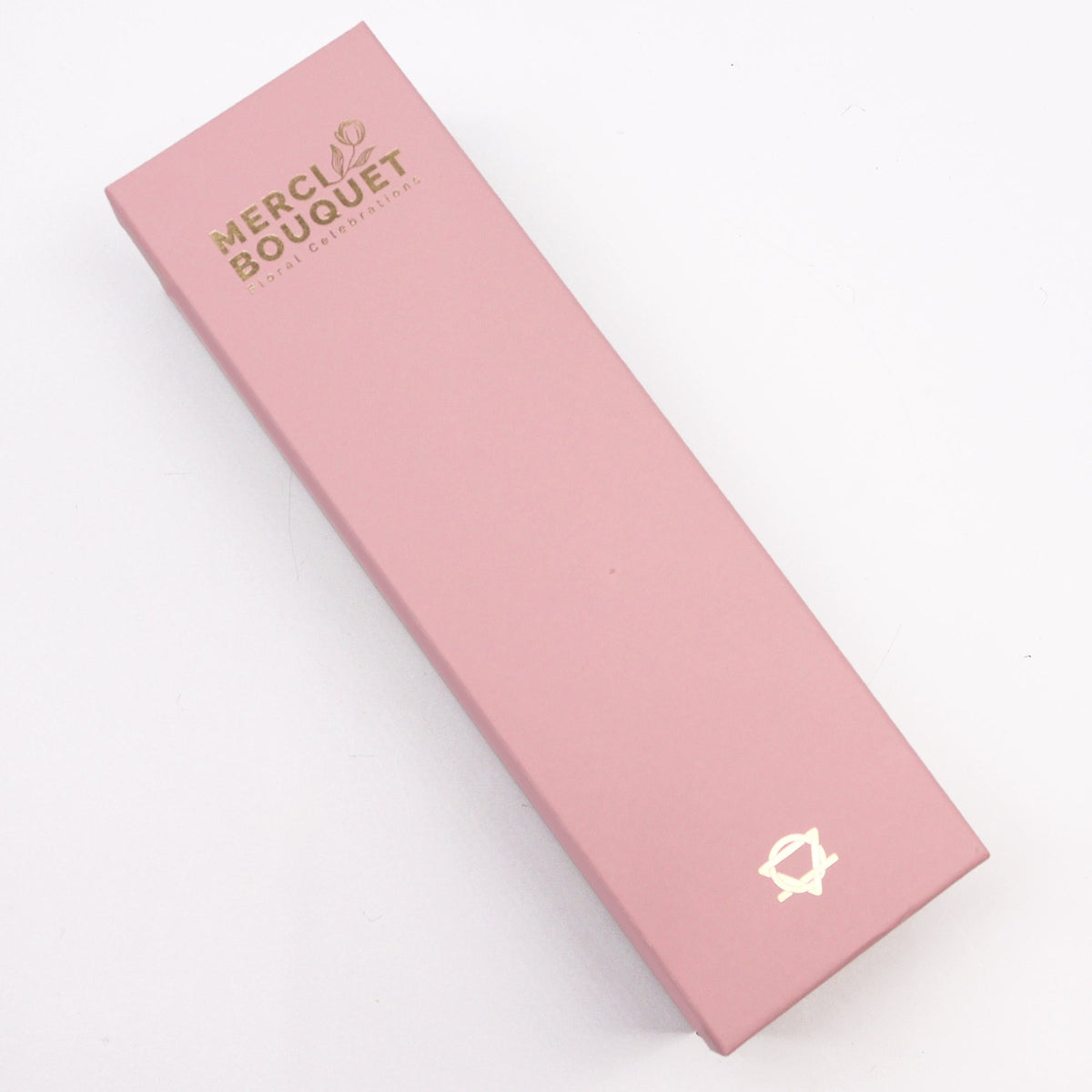 Luxury Soap Flowers - Long - Pinks shown as a closed blush-pink rectangular box with gold lettering and emblem by Quintessential Holistic Health Ltd