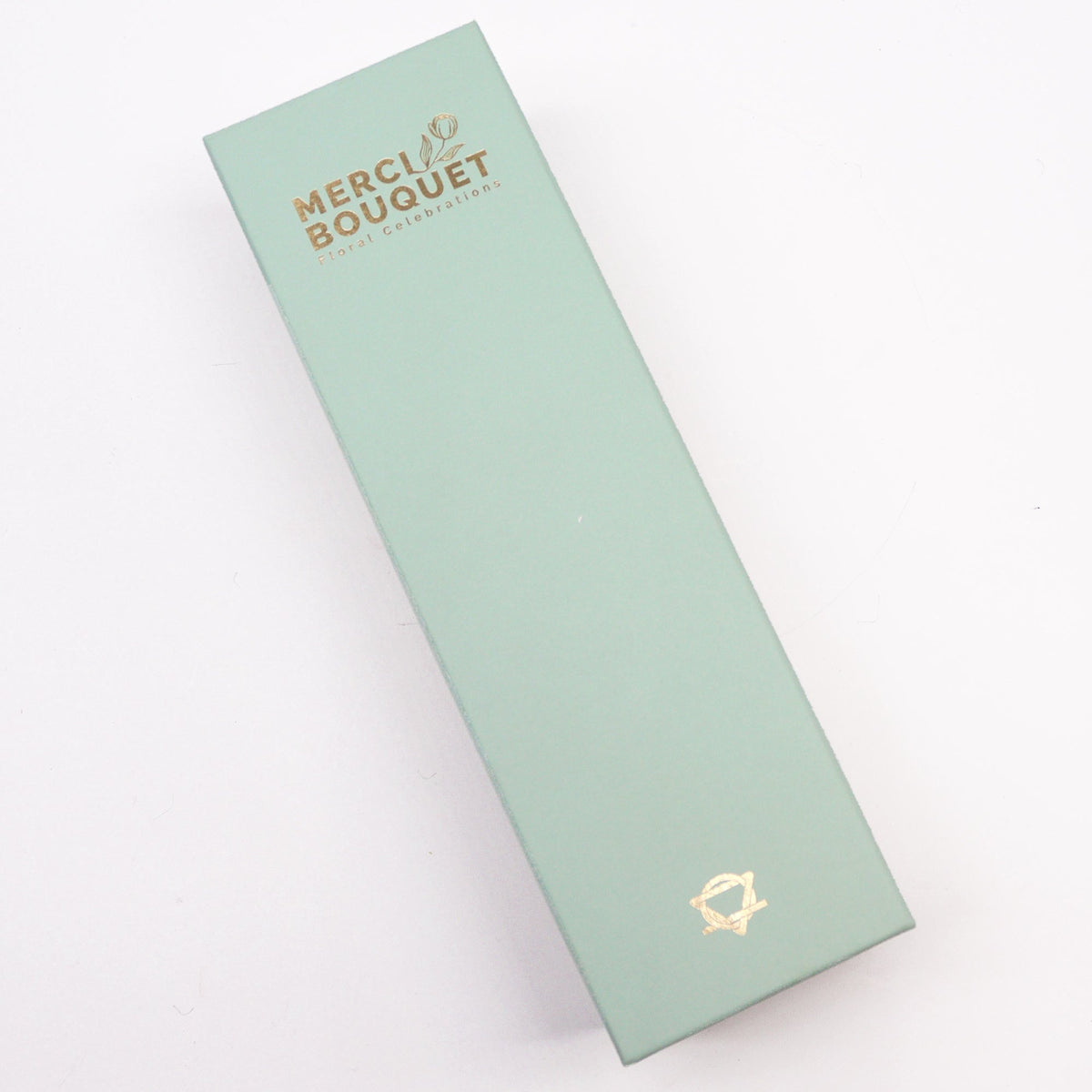 Luxury Soap Flowers - Long - Whites and Ivory, shown as a closed pale sage-green rectangular box with gold lettering and emblem, by Quintessential Holistic Health Ltd