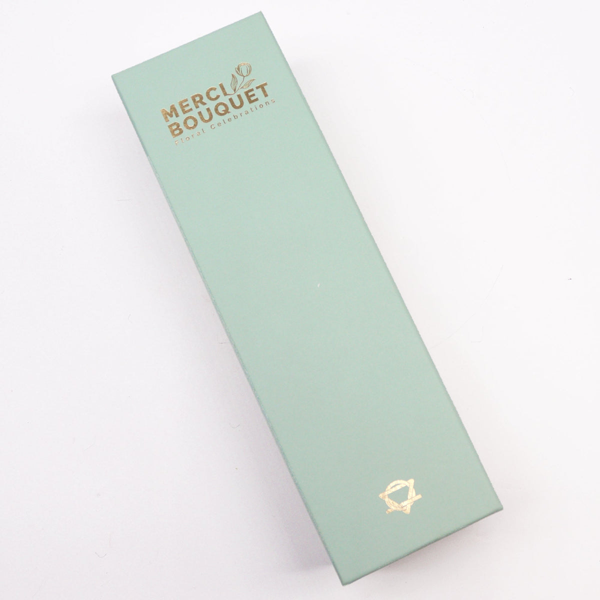 Luxury Soap Flowers - Long - Yellows and Greens, shown as a closed pale green rectangular box with gold lettering and emblem, by Quintessential Holistic Health Ltd