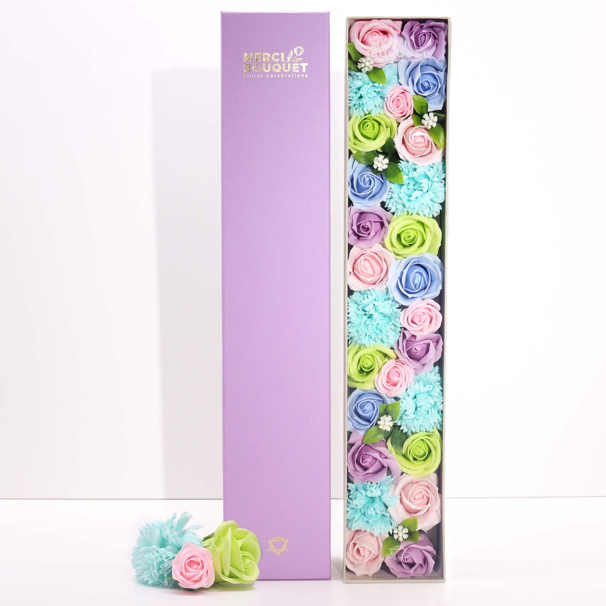 Luxury Soap Flowers - Extra Long - Blues, with pastel blue, pink, purple and green blooms beside an upright lilac cover by Quintessential Holistic Health Ltd