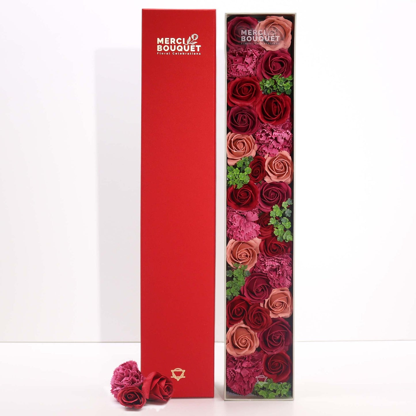 Luxury Soap Flowers - Extra Long - Vintage Reds, with burgundy, dusky red and green blooms beside an upright deep-red cover by Quintessential Holistic Health Ltd