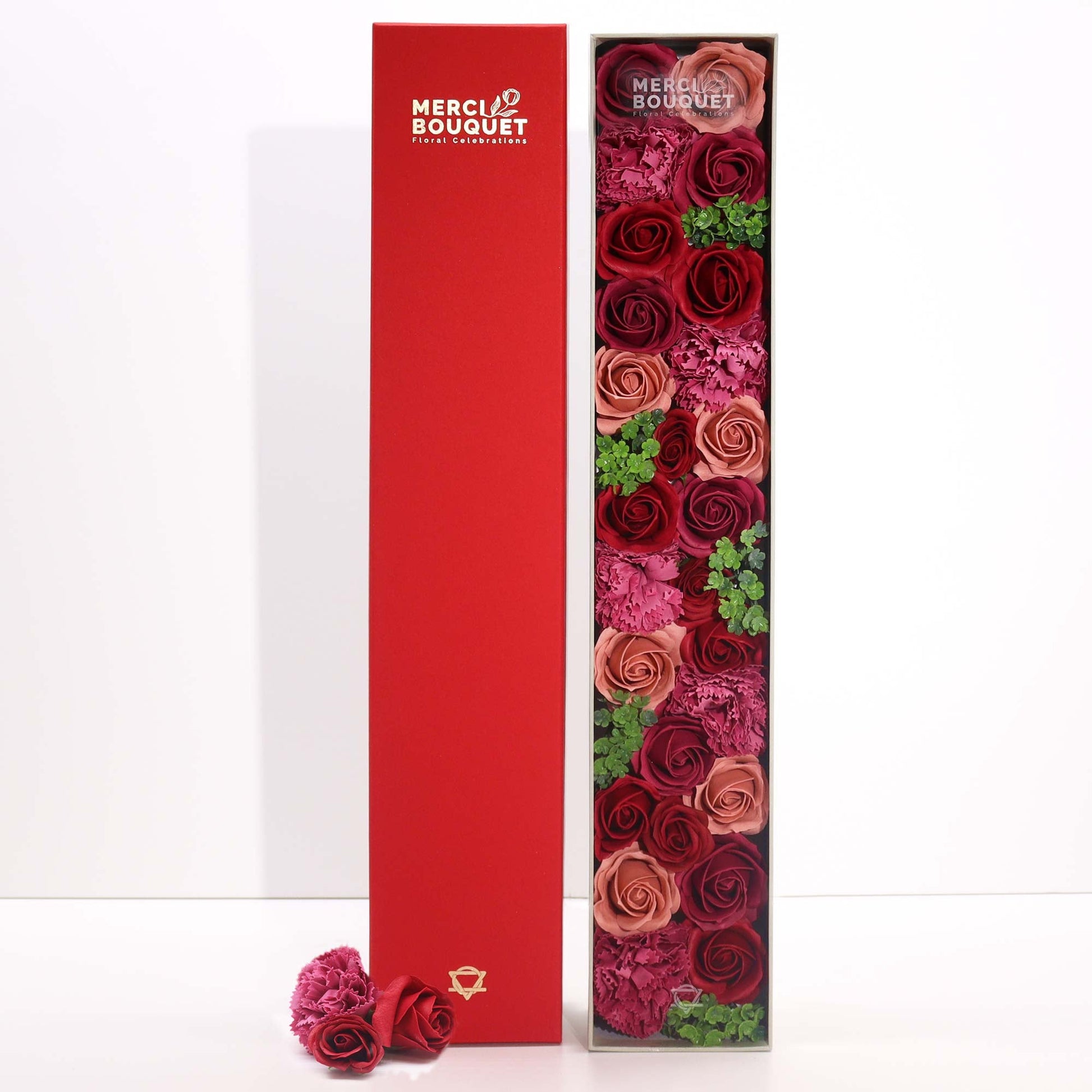 Luxury Soap Flowers - Extra Long - Vintage Reds, with burgundy, dusky red and green blooms beside an upright deep-red cover by Quintessential Holistic Health Ltd