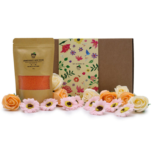 May Chang bath soak gift set with gold pouch, floral brown box and peach, pink and white flowers from Quintessential Holistic Health.