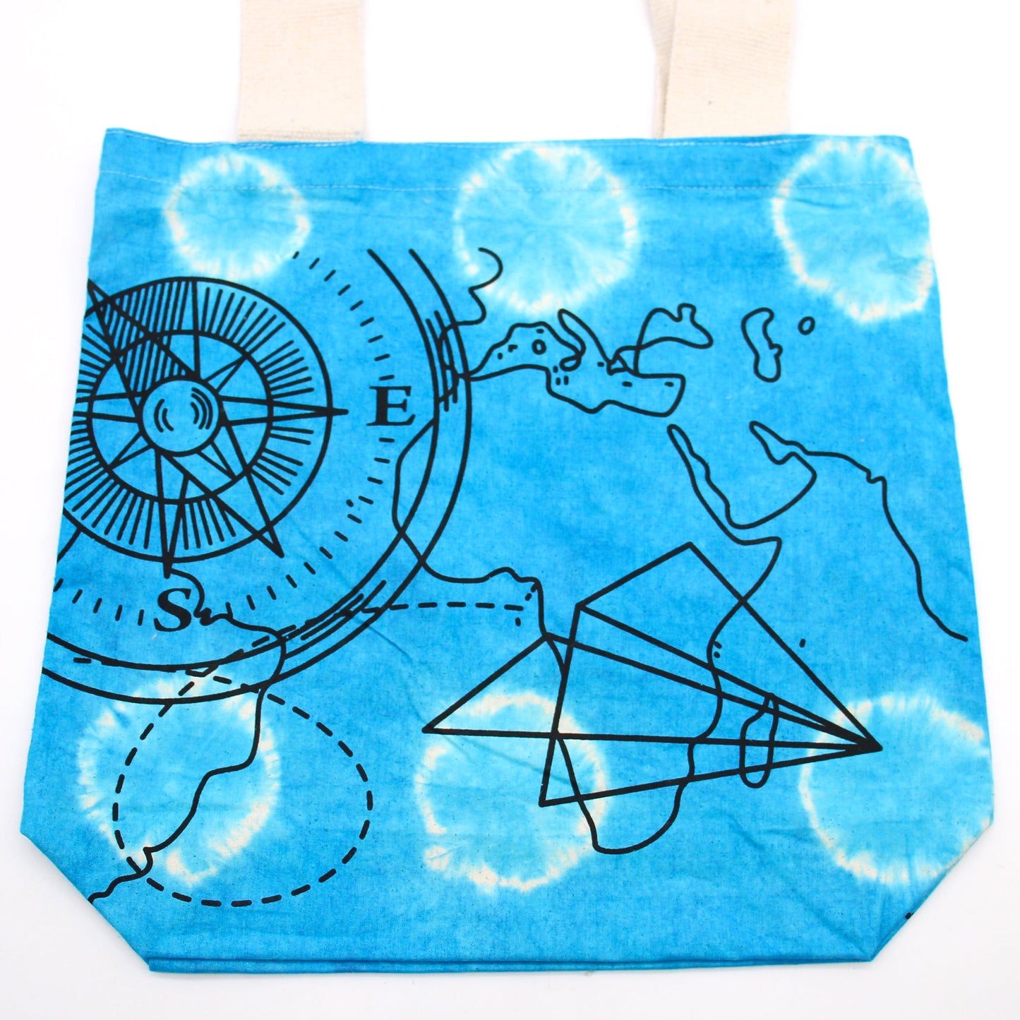Tie-Dyed Cotton Tote Bag - Compass - Blue, with a large black compass, map outlines and overlapping paper-plane design by Quintessential Holistic Health Ltd