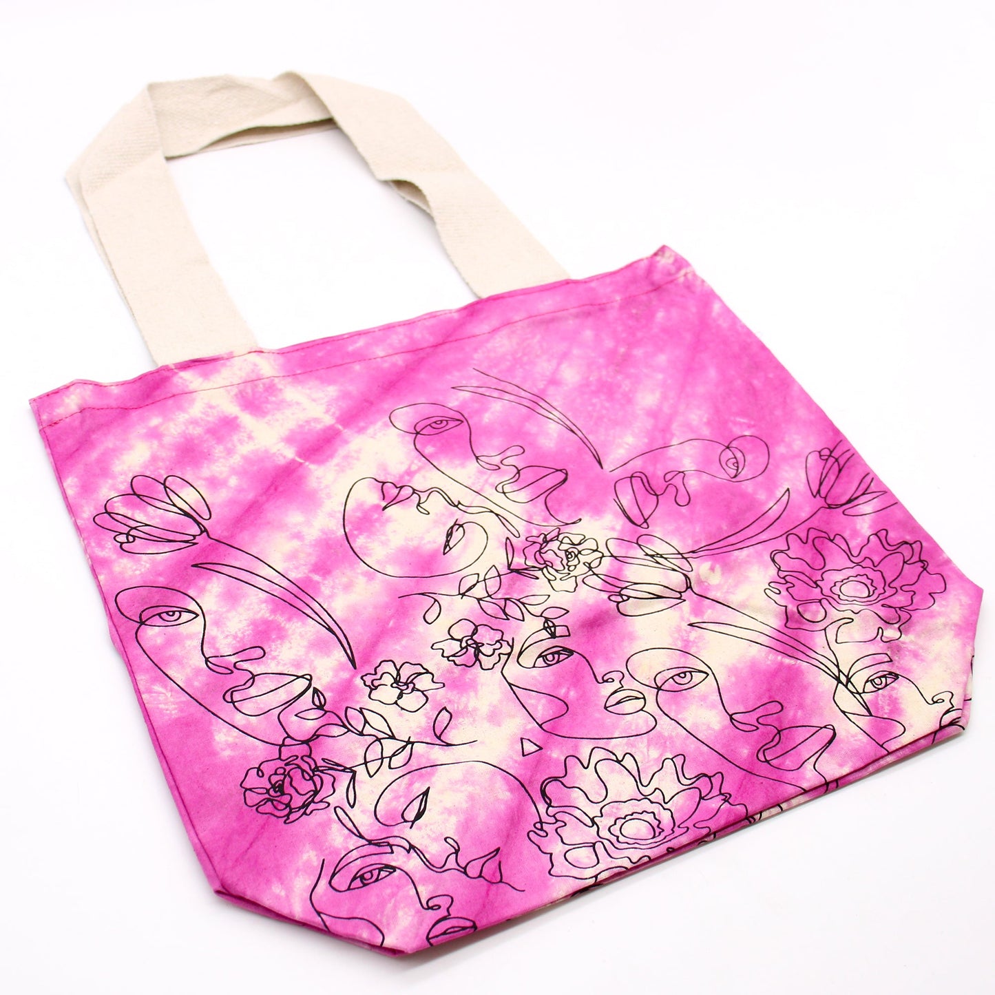 Tie-Dyed Cotton Tote Bag - Pretty Face - Pink with line-drawn faces, leaves and flowers across diagonal white bands by Quintessential Holistic Health Ltd