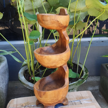 Hand-Carved Teak Root Three-Tier Standing Bowl, with three graduated bowls and a twisting upright form beside pond plants by Quintessential Holistic Health Ltd