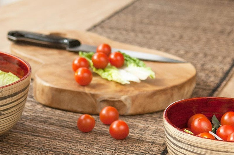 Hand-Carved Sustainable Teak Chopping Board - Medium, thick brown board topped with tomatoes and lettuce beside a knife, by Quintessential Holistic Health Ltd