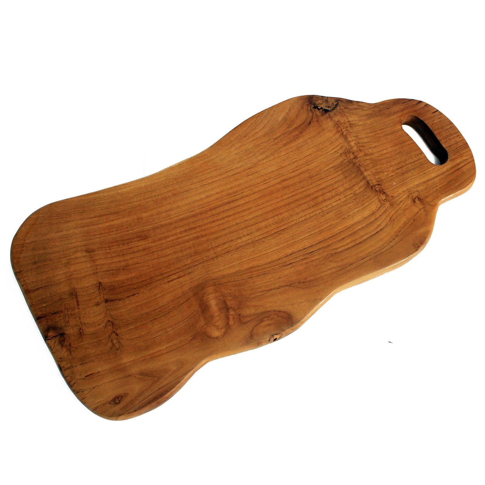 A hand-carved, irregular shaped teak wood chopping board with a handle cut out on the side.