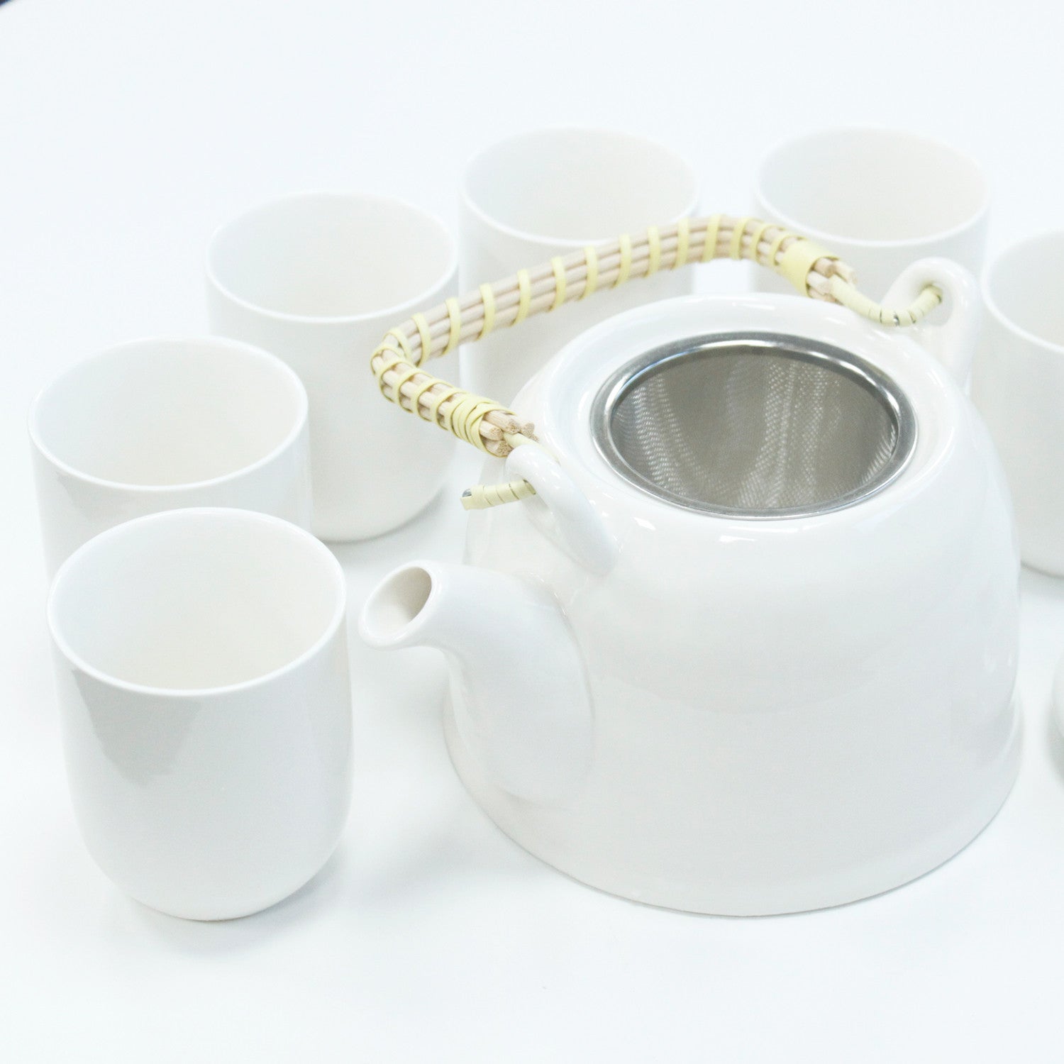 650ml Classic Design White Glazed Ceramic Herbal Teapot with a Strainer and a 6 Matching Cup Set product packaging on clean background from Quintessential Holistic Health Ltd