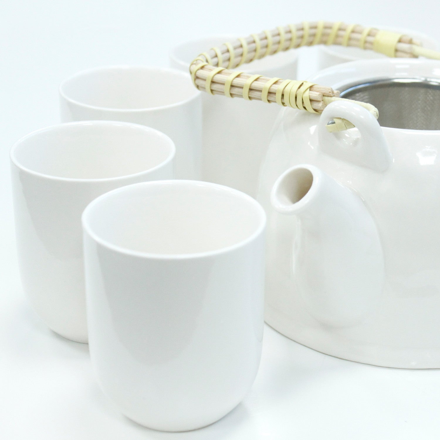 650ml Classic Design White Glazed Ceramic Herbal Teapot with a Strainer and a 6 Matching Cup Set product packaging on clean background from Quintessential Holistic Health Ltd