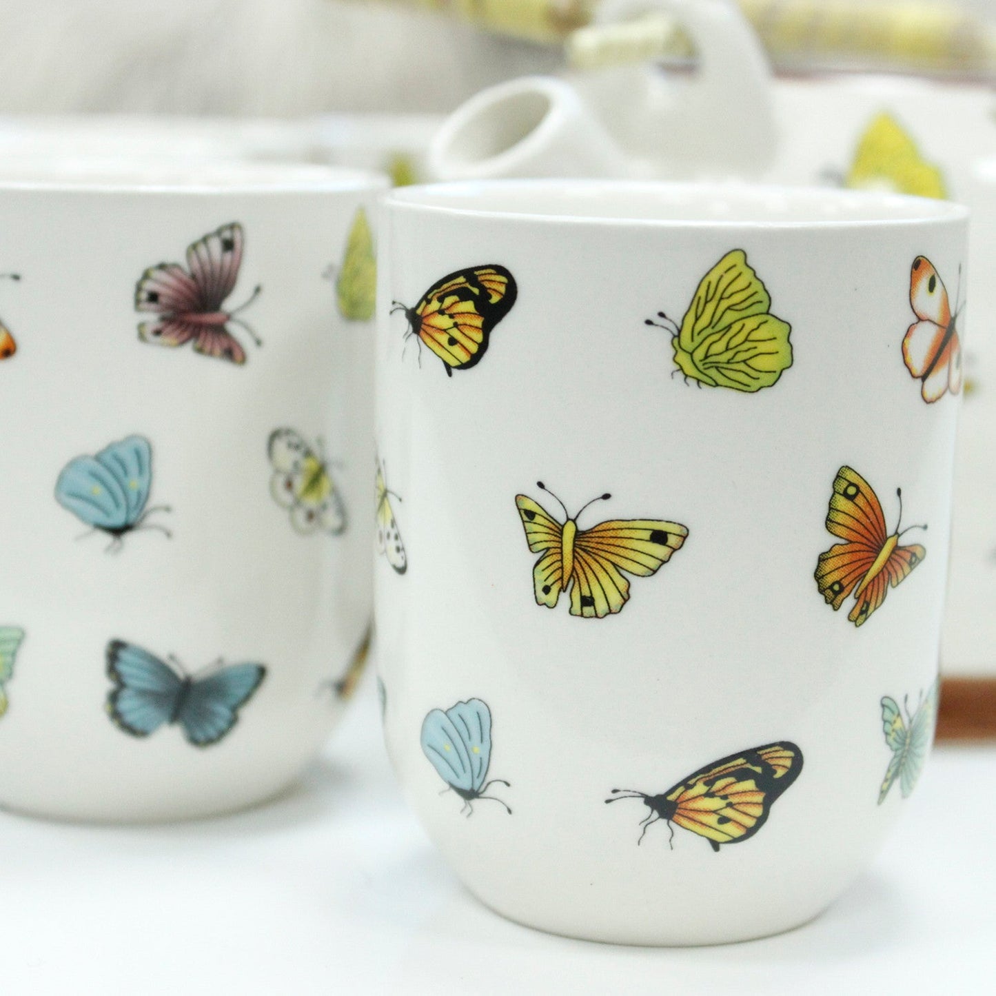 650ml Butterflies Design White Glazed Ceramic Teapot with a Strainer and a 6 Matching Cup Set product packaging on clean background from Quintessential Holistic Health Ltd