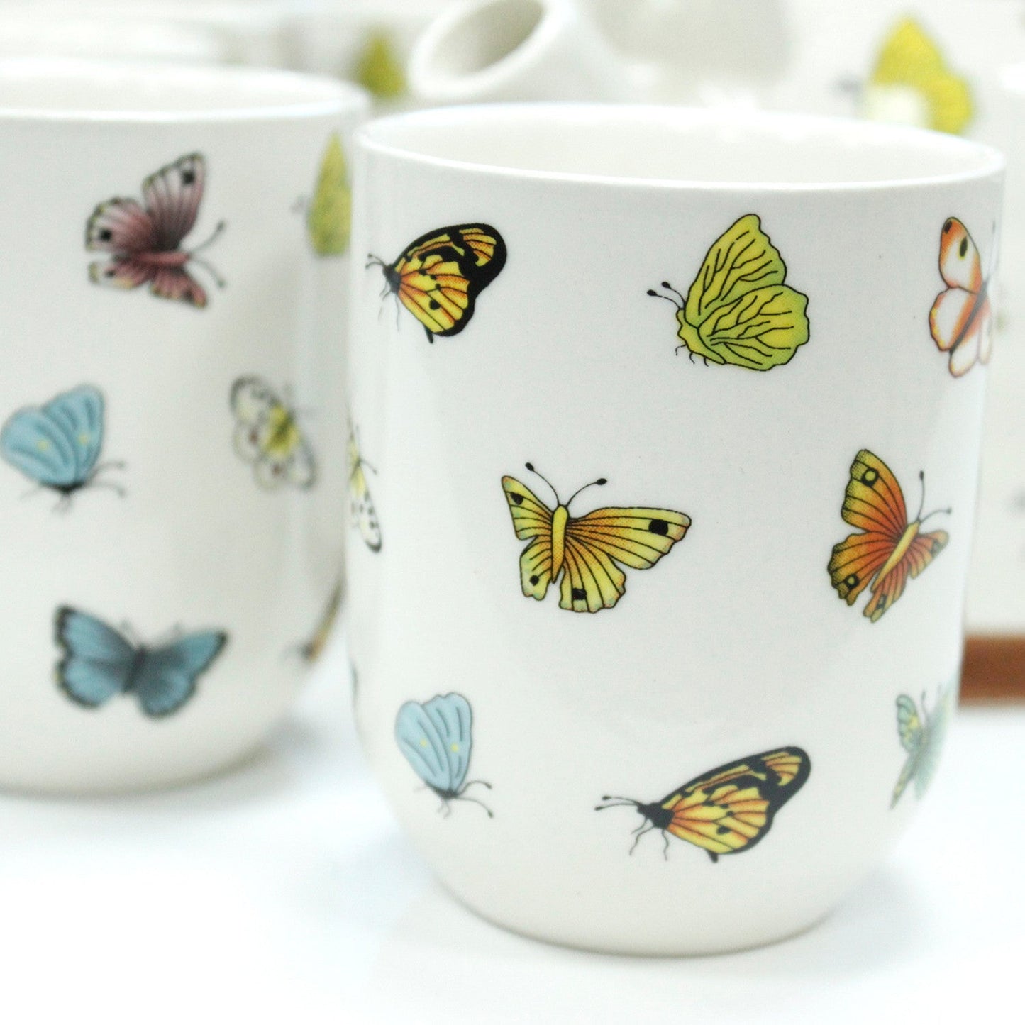 650ml Butterflies Design White Glazed Ceramic Teapot with a Strainer and a 6 Matching Cup Set product packaging on clean background from Quintessential Holistic Health Ltd