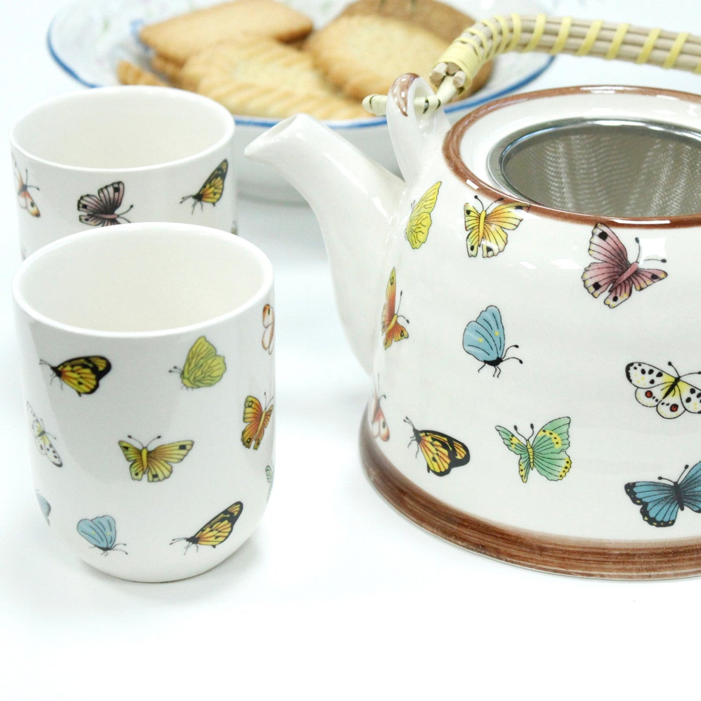650ml Butterflies Design White Glazed Ceramic Teapot with a Strainer and a 6 Matching Cup Set product packaging on clean background from Quintessential Holistic Health Ltd