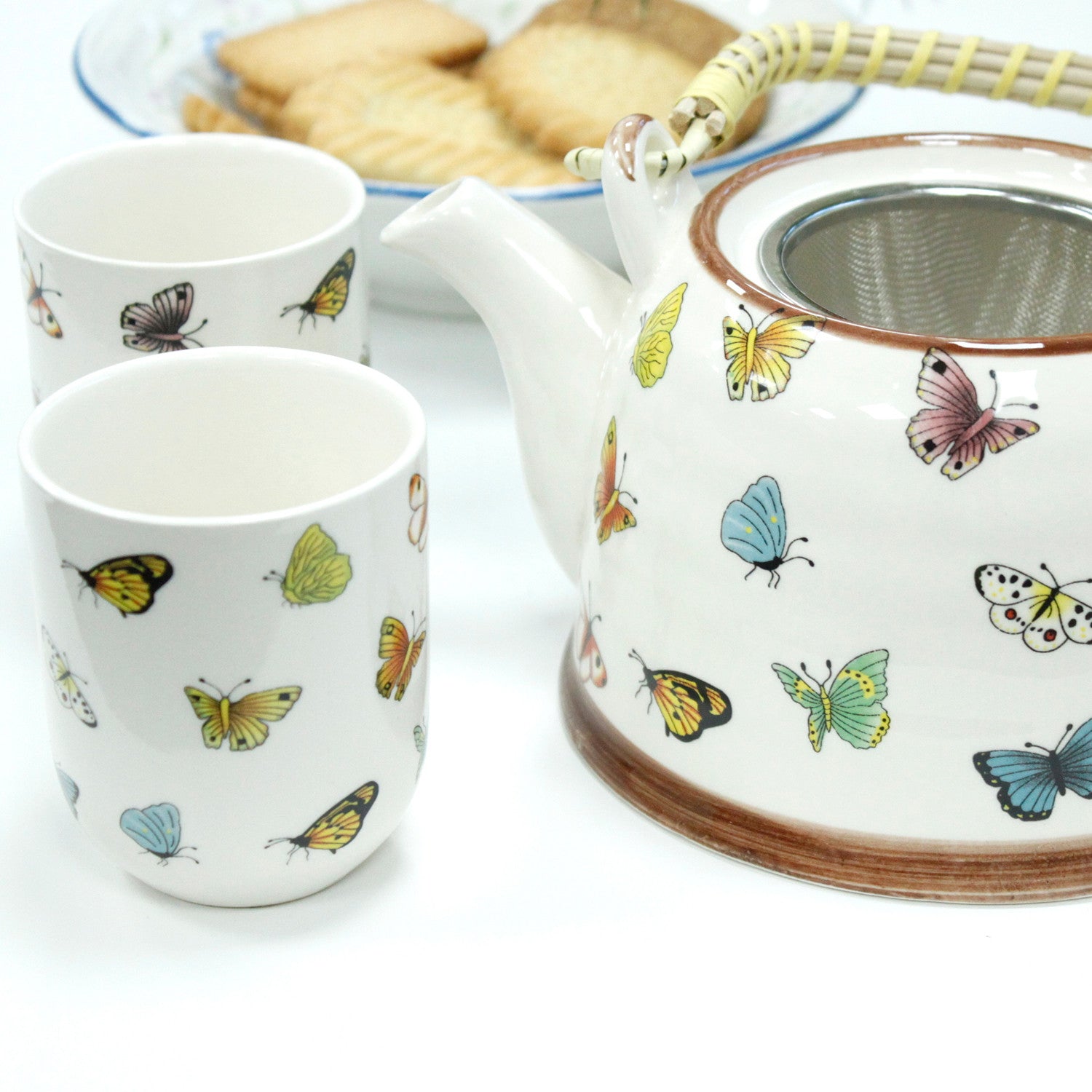 650ml Butterflies Design White Glazed Ceramic Teapot with a Strainer and a 6 Matching Cup Set product packaging on clean background from Quintessential Holistic Health Ltd