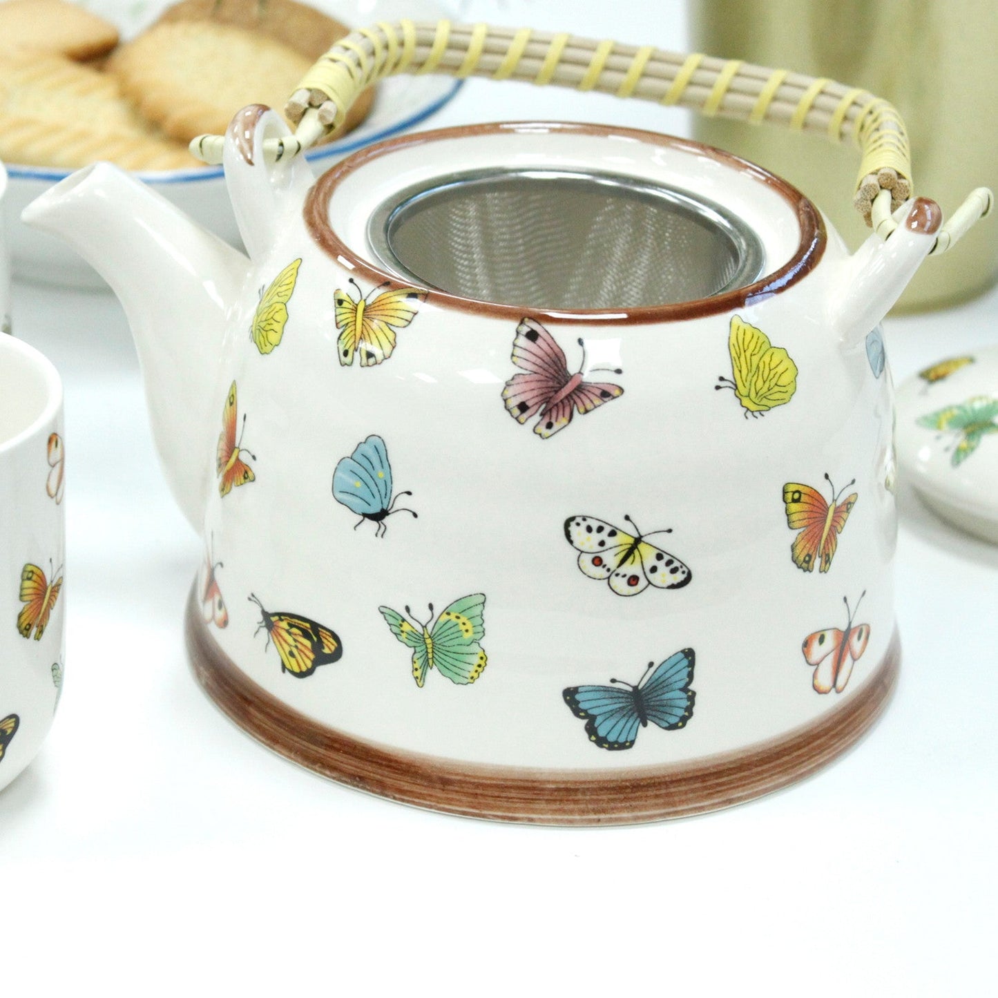 650ml Butterflies Design White Glazed Ceramic Teapot with a Strainer and a 6 Matching Cup Set product packaging on clean background from Quintessential Holistic Health Ltd