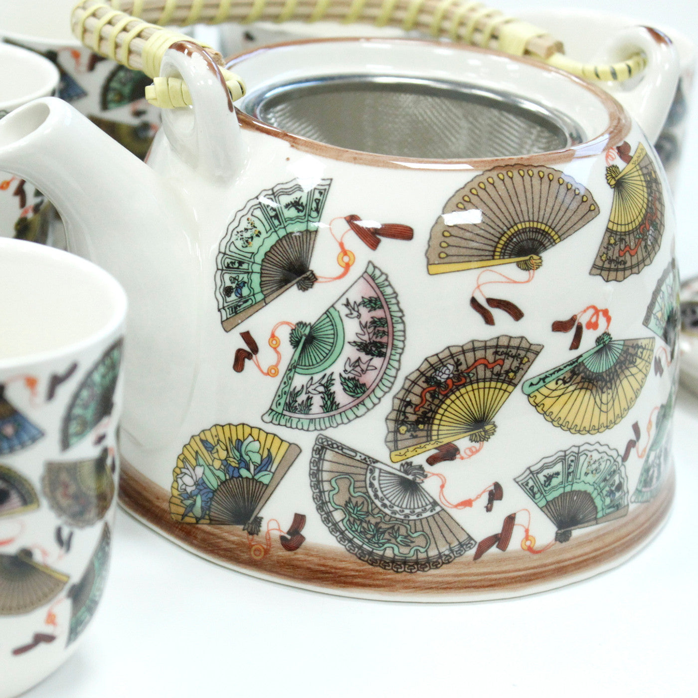 650ml Chinese Fan Design White Glazed Ceramic Teapot with a Strainer and a 6 Matching Cup Set product packaging on clean background from Quintessential Holistic Health Ltd