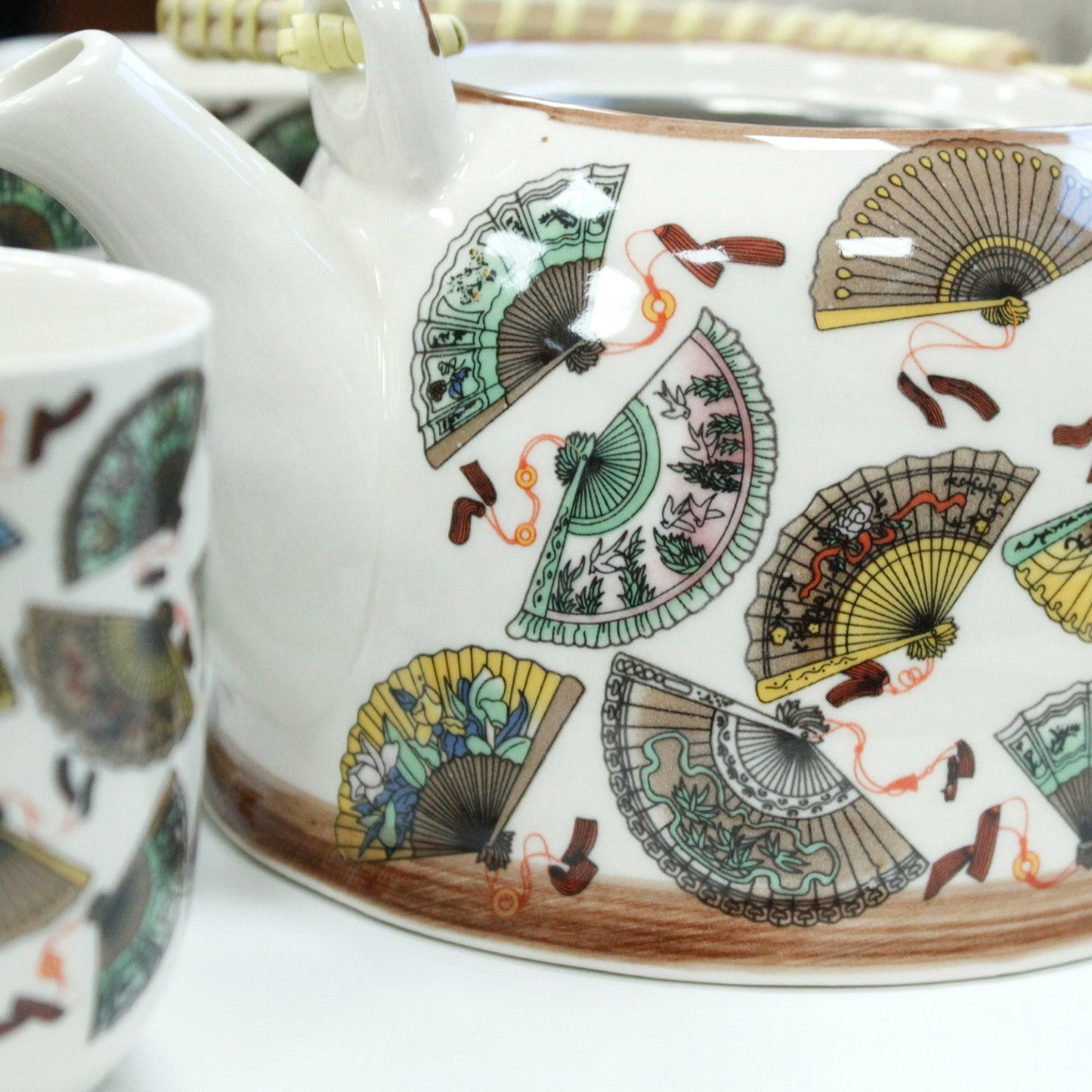 650ml Chinese Fan Design White Glazed Ceramic Teapot with a Strainer and a 6 Matching Cup Set product packaging on clean background from Quintessential Holistic Health Ltd