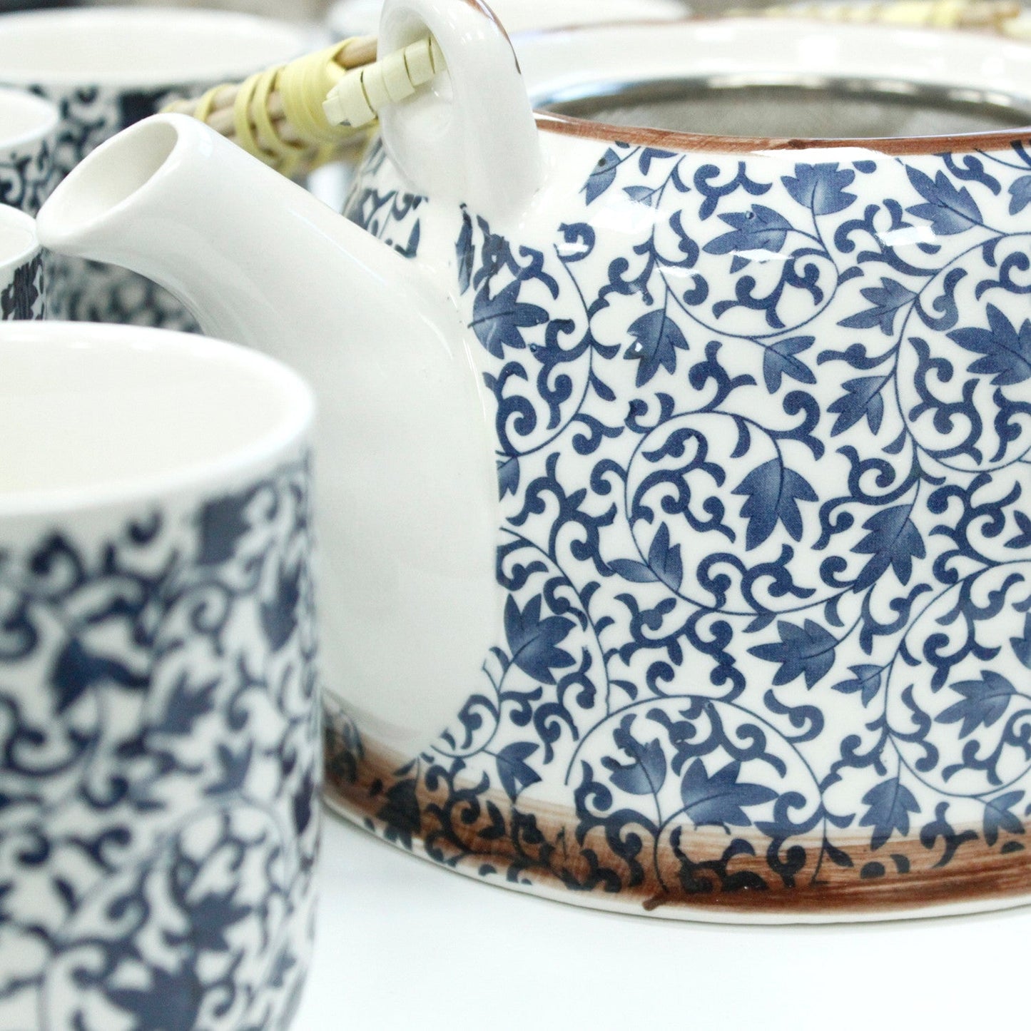 650ml Blue Patterned Design White Ceramic Herbal Teapot with a Strainer and a 6 Matching Cup Set product packaging on clean background from Quintessential Holistic Health Ltd