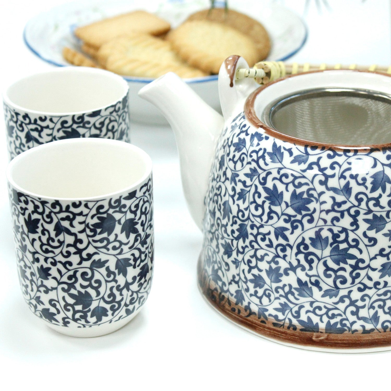 650ml Blue Patterned Design White Ceramic Herbal Teapot with a Strainer and a 6 Matching Cup Set product packaging on clean background from Quintessential Holistic Health Ltd