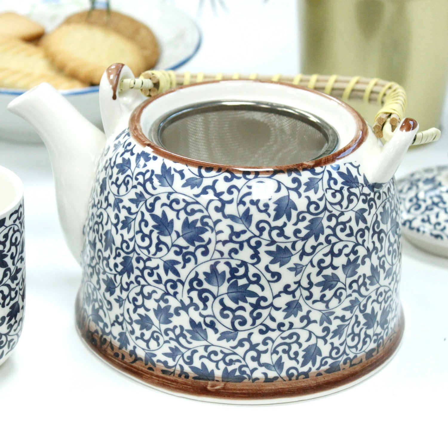 650ml Blue Patterned Design White Ceramic Herbal Teapot with a Strainer and a 6 Matching Cup Set product packaging on clean background from Quintessential Holistic Health Ltd