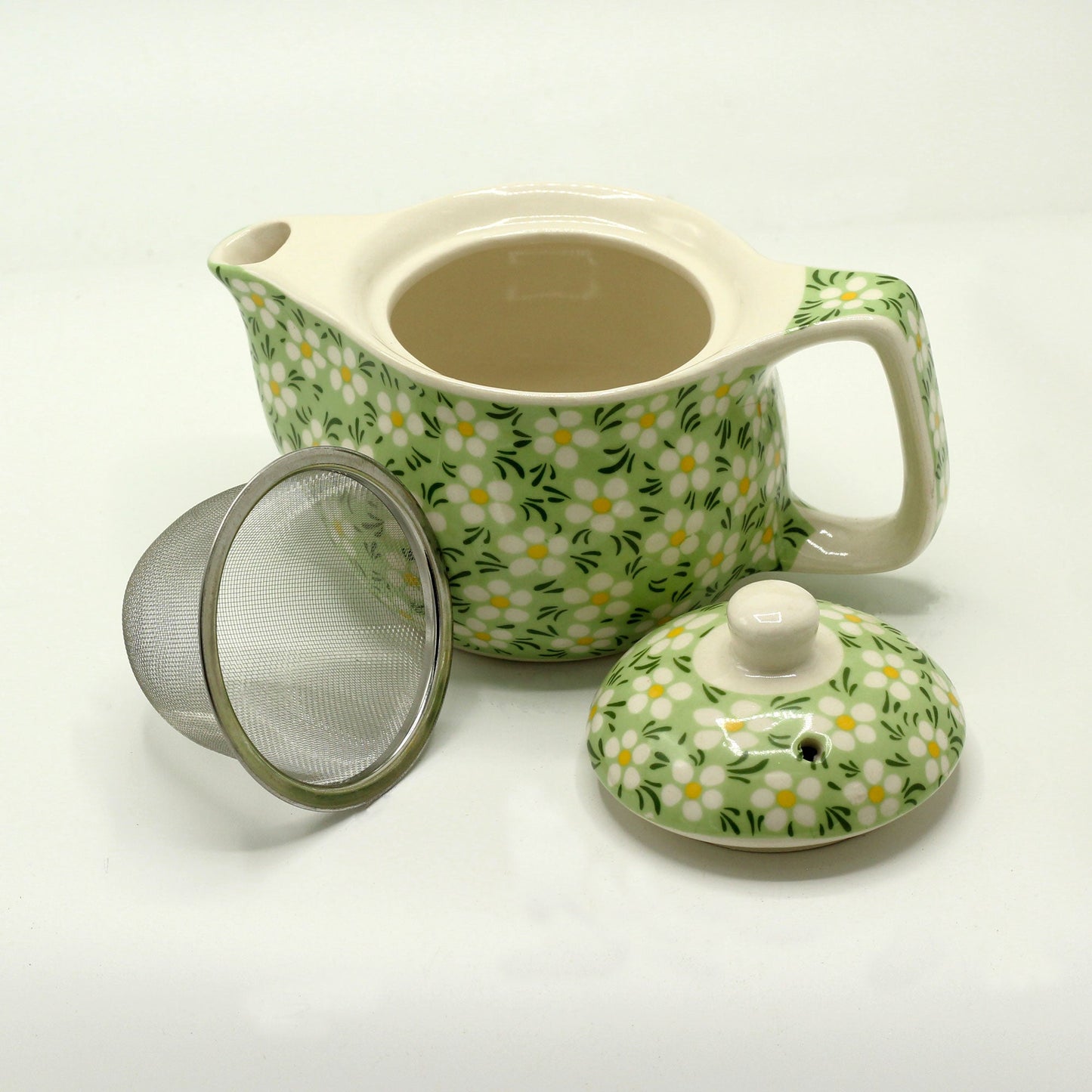 350ml Small Ceramic Green Daisy Design Herbal Teapot and Strainer product packaging on clean background from Quintessential Holistic Health Ltd