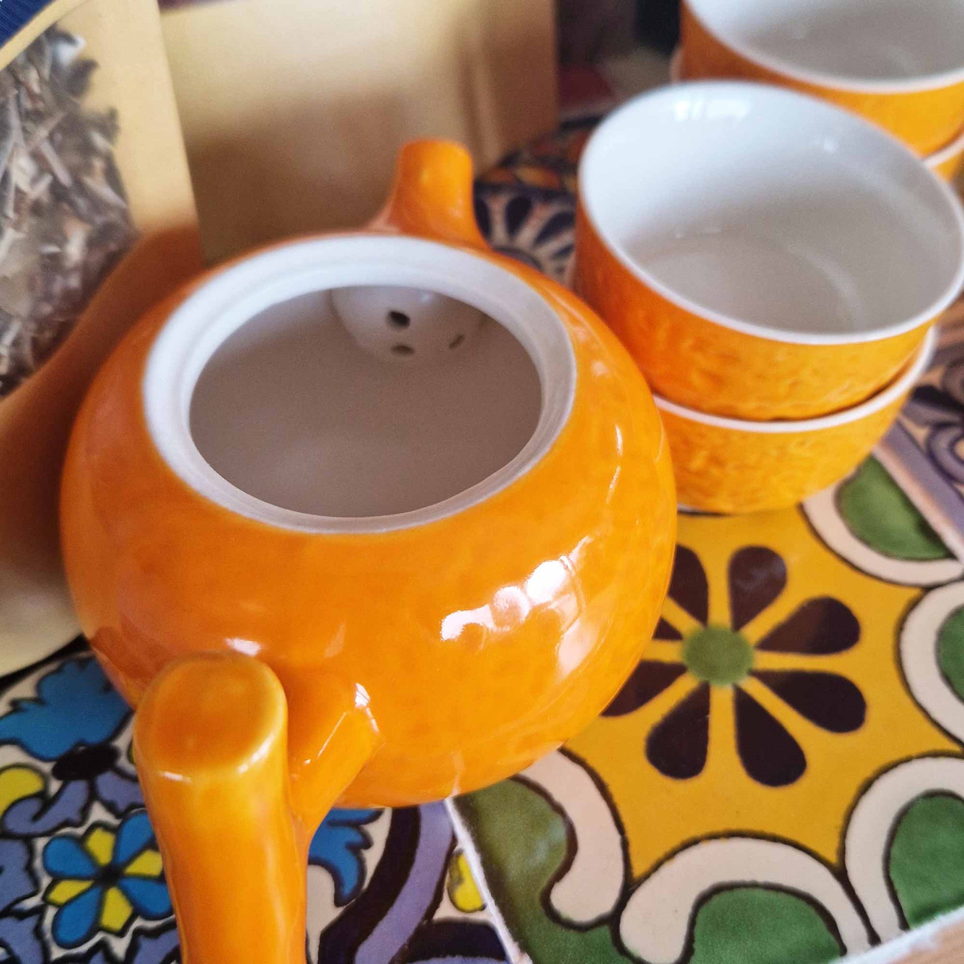 200ml Small Glazed Orange Ceramic Herbal Teapot with a 4 Matching Cup Set product packaging on clean background from Quintessential Holistic Health Ltd
