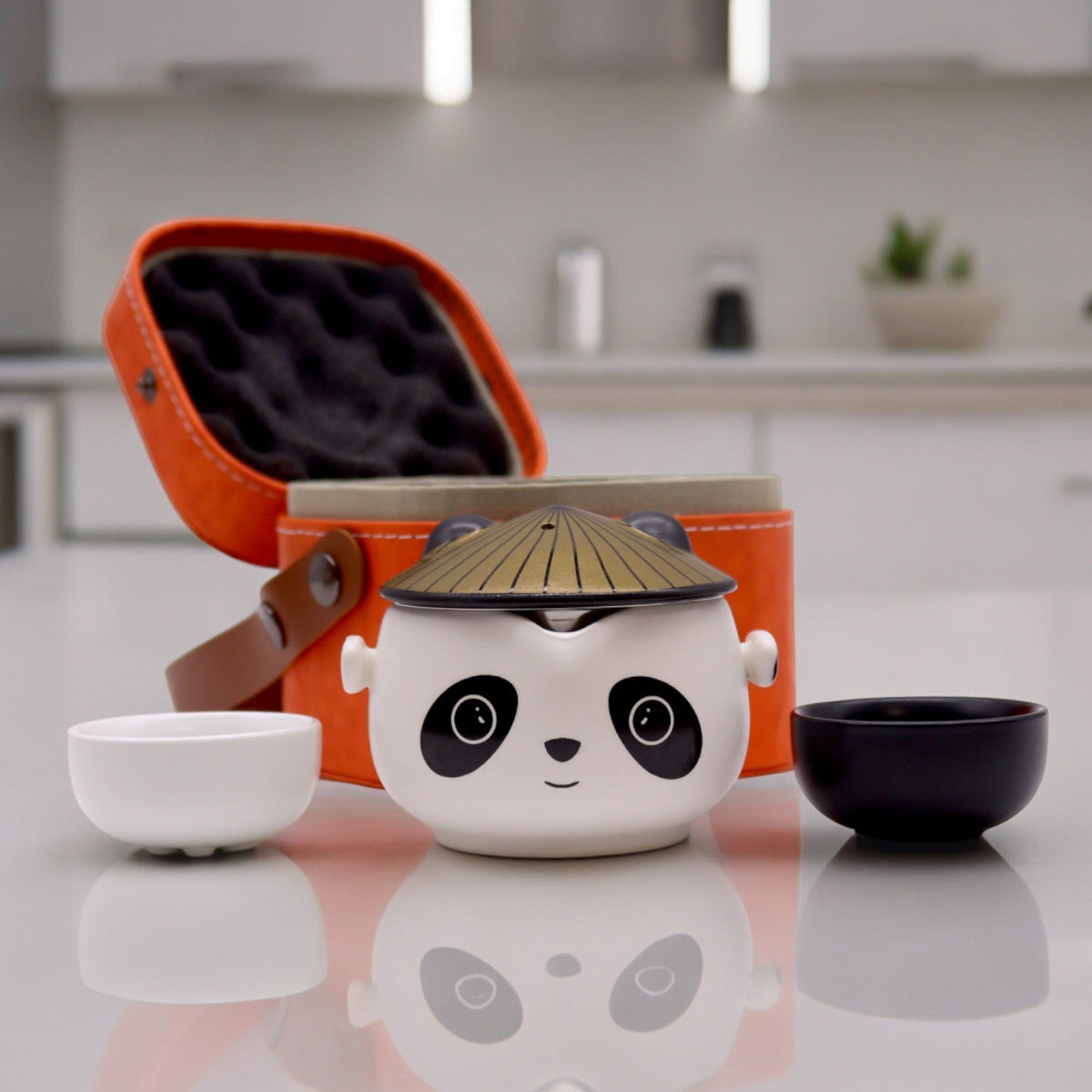 Kung Fu Panda Teapot Set - 2 Cups, Black/White, Orange Case, 210 ml with a gold-toned hat lid, two cups and an orange case, by Quintessential Holistic Health Ltd