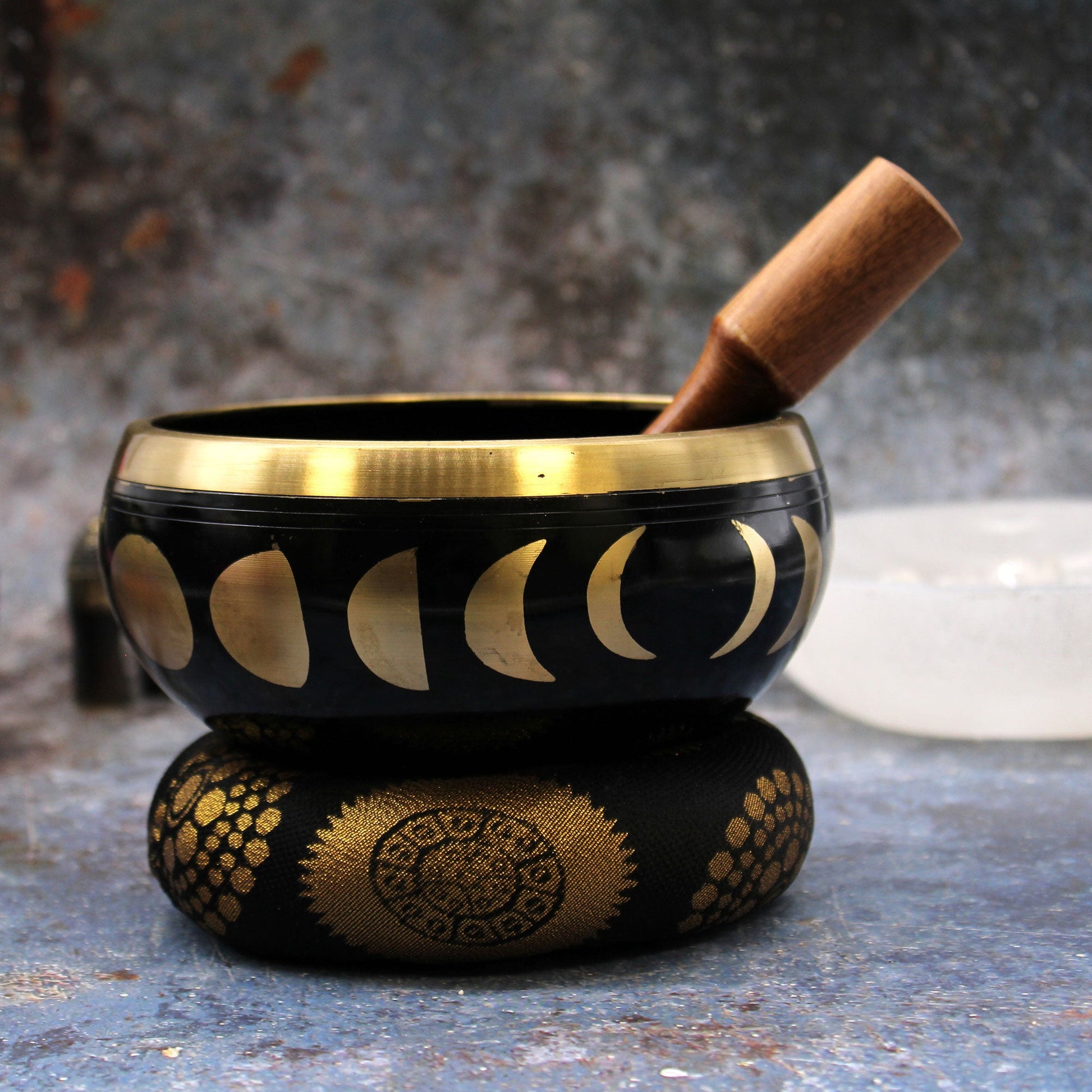 14cm Brass Singing Bowl Set- Moon Phase / Black product packaging on clean background from Quintessential Holistic Health Ltd