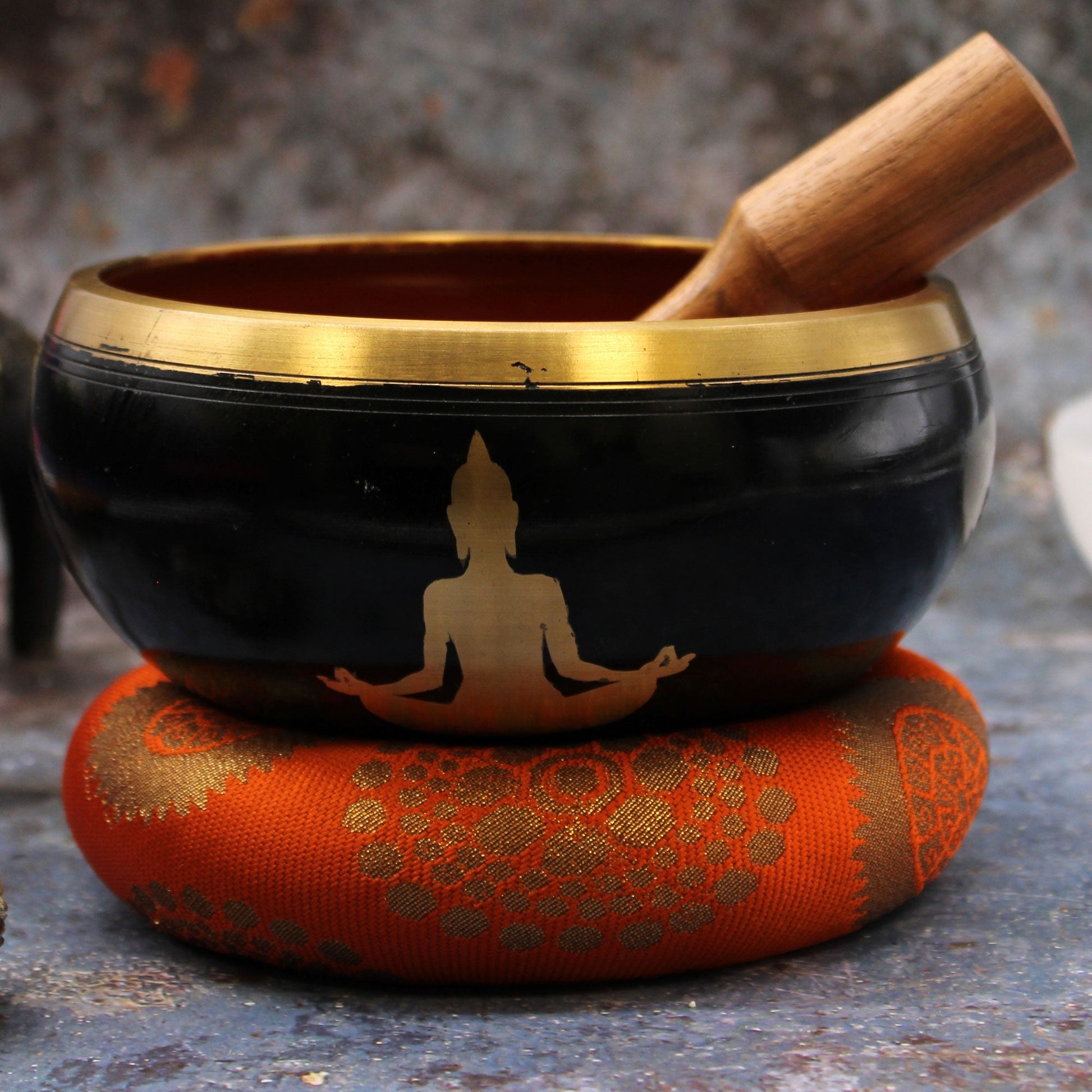 14cm Brass Singing Bowl Set- Buddha / Black and Orange product packaging on clean background from Quintessential Holistic Health Ltd