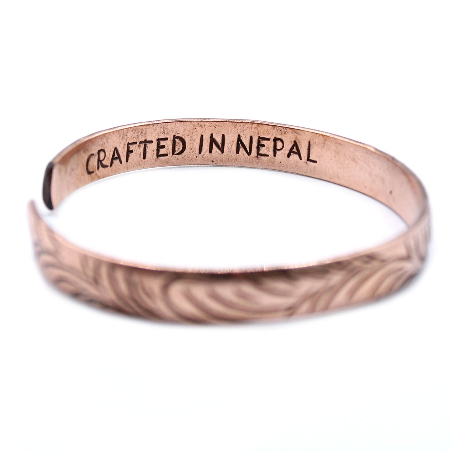 Handcrafted Copper Tibetan Bracelet - Slim Tribal Swirls product packaging on clean background from Quintessential Holistic Health Ltd