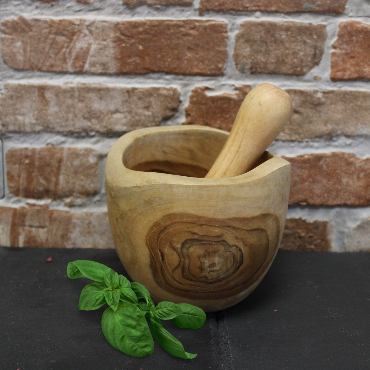 Ergo Teak Pestle & Mortar - Medium, with the pestle inside the bowl and circular wood grain visible on the front by Quintessential Holistic Health Ltd