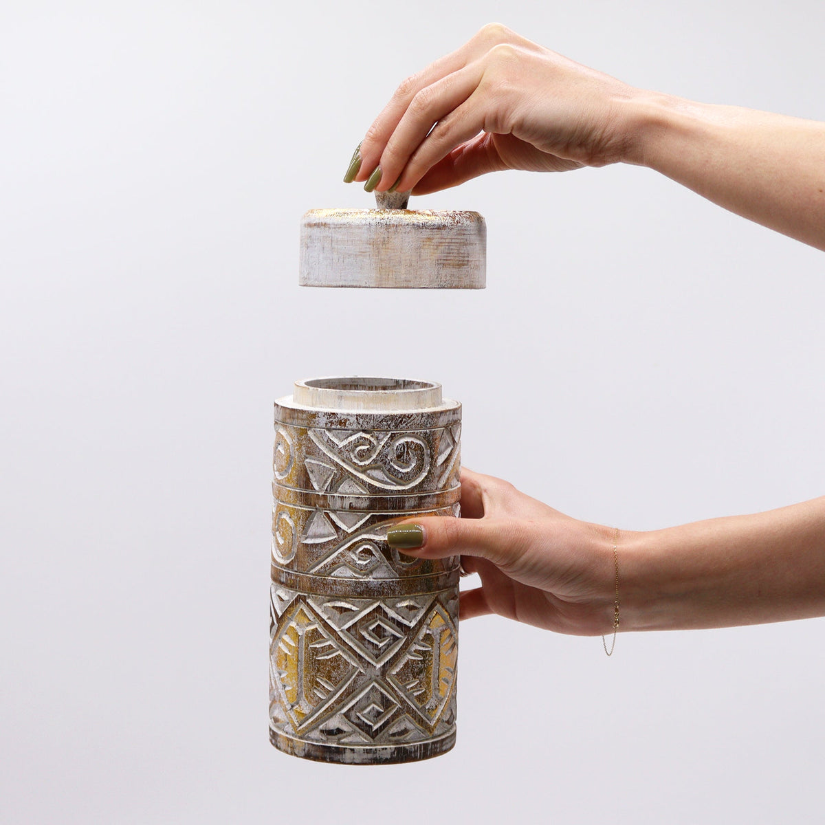 Tall Embossed Canvas-on-Wood Storage Container - White and Gold, patterned cylinder held in two hands as its lid is lifted by Quintessential Holistic Health Ltd