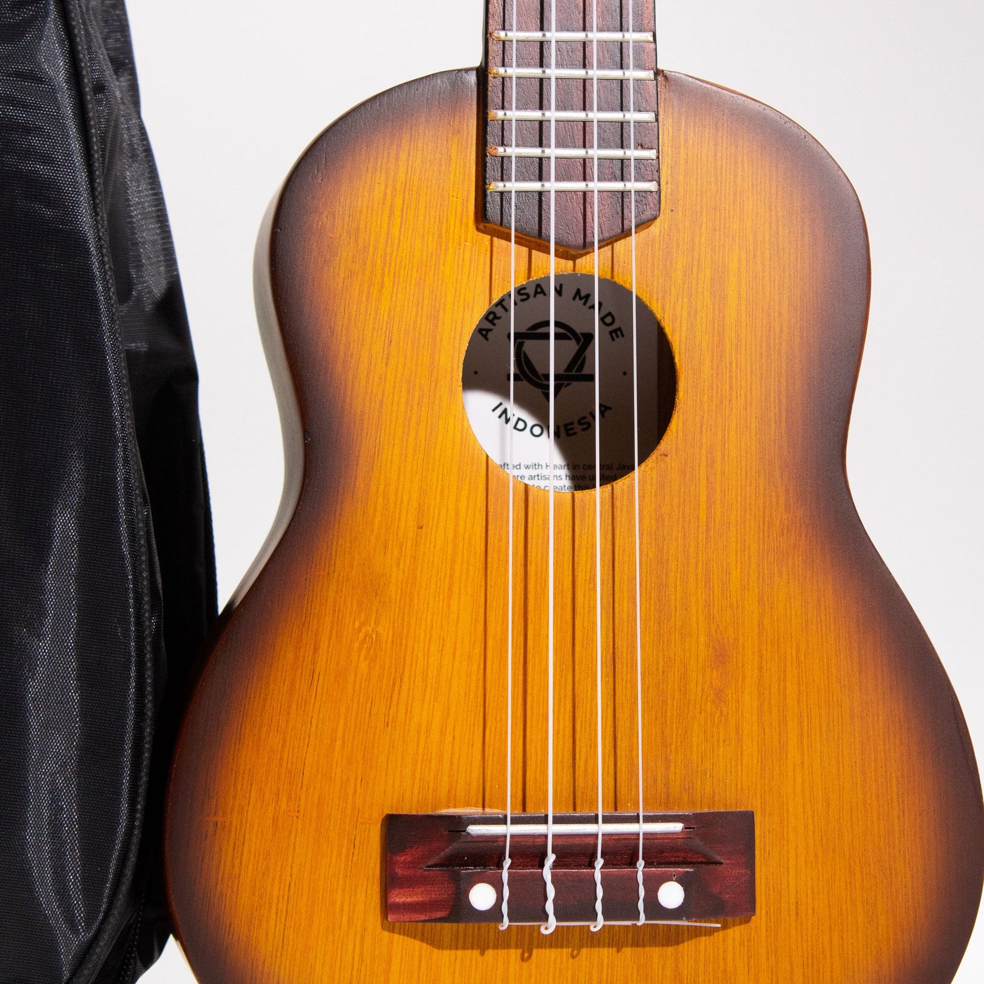 Artisan Handmade 4 String Rosewood Ukulele - Orange Sunburst product packaging on clean background from Quintessential Holistic Health Ltd