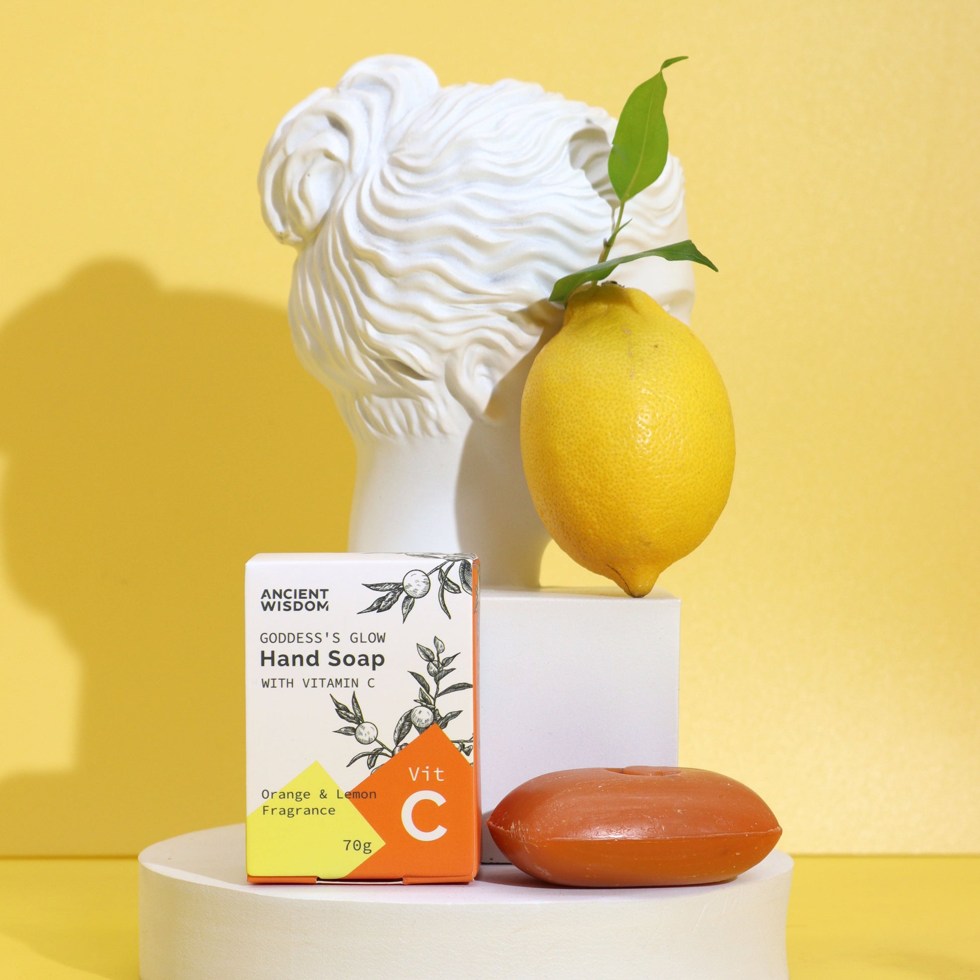 Vitamin C Skincare - Brightening Hand Soap with Essential Oils, displayed with an orange bar, lemon and white bust, by Quintessential Holistic Health Ltd