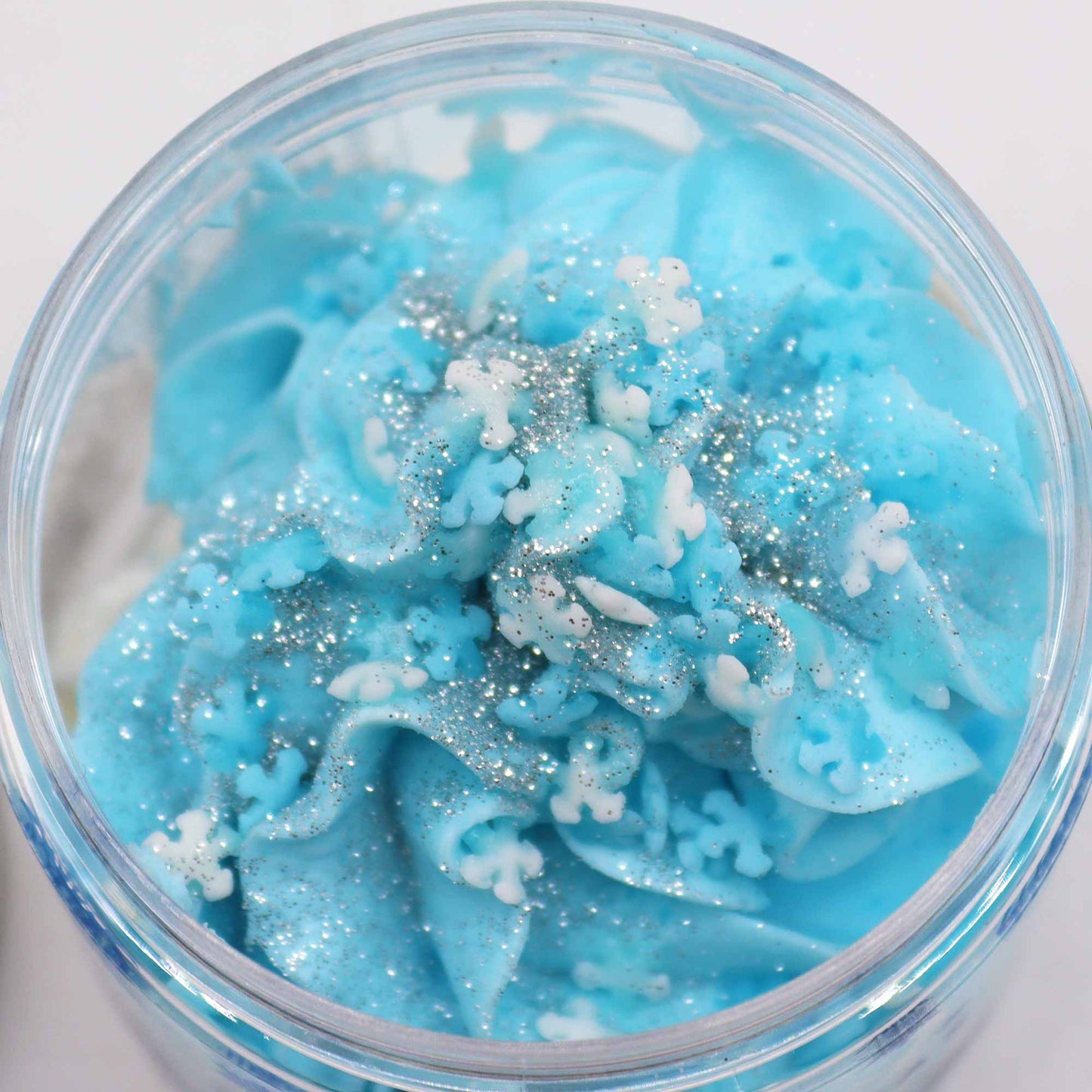 Vegan-Friendly Whipped Soap - White Christmas - 120g, close-up of bright blue piped swirls with white granules by Quintessential Holistic Health Ltd