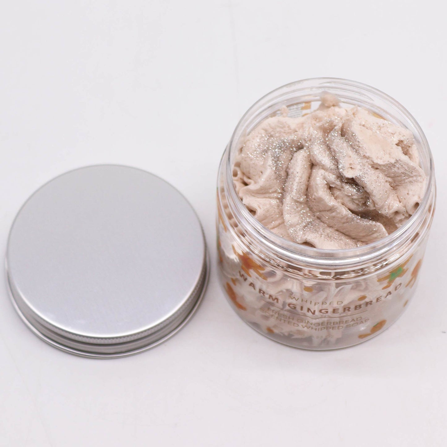 Handcrafted Vegan-Friendly Whipped Soap - Warm Gingerbread - 120g, open clear jar beside its silver lid, by Quintessential Holistic Health Ltd