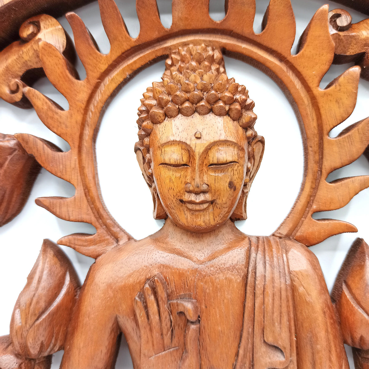 Handmade 40cm Suar Wood Plaque - Buddha and Lotus Flower showing a close-up of the Buddha, raised hand and sun-ray carving by Quintessential Holistic Health Ltd