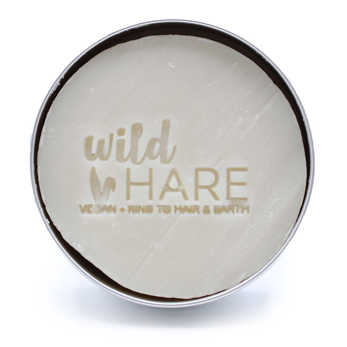 60g Vegan-Friendly Shampoo & Conditioner Bar - Hairy Coconut, pale round bar embossed with the Wild Hare logo in an open tin by Quintessential Holistic Health Ltd