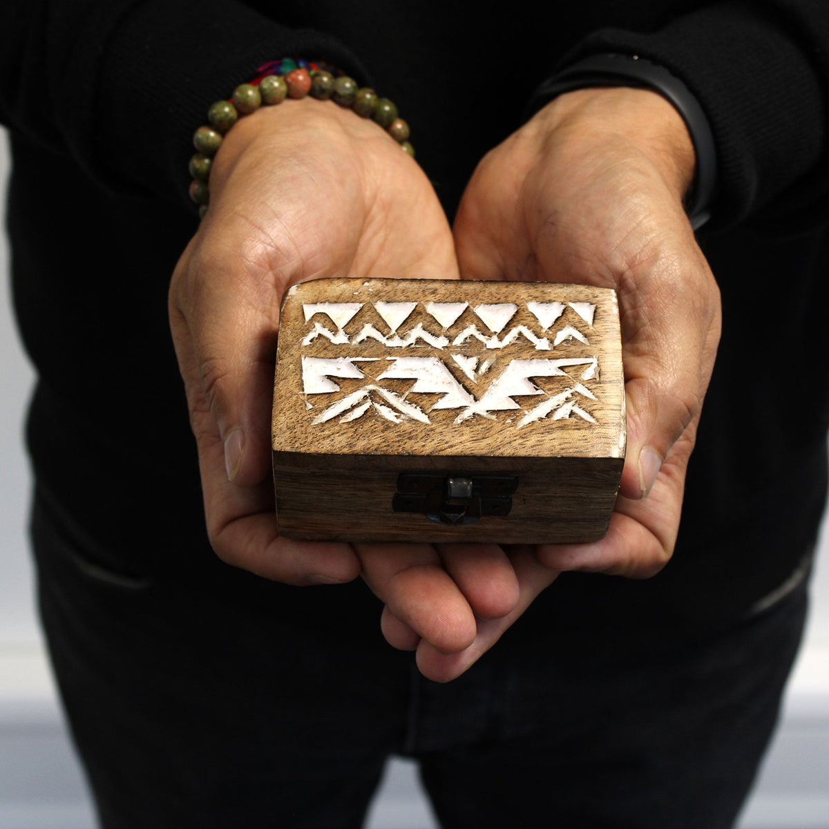 Mango Wood Keepsake Box - Small - Whitewash - Slavic Design, closed box held in two hands with white zigzag motifs across the lid by Quintessential Holistic Health Ltd