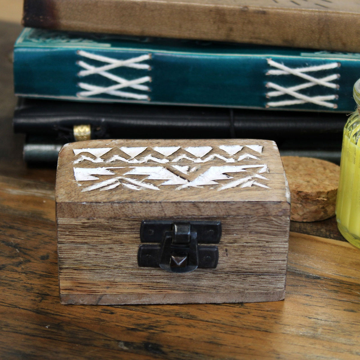 Mango Wood Keepsake Box - Small - Whitewash - Slavic Design, closed box with white zigzag lid motifs in front of teal stacked books by Quintessential Holistic Health Ltd