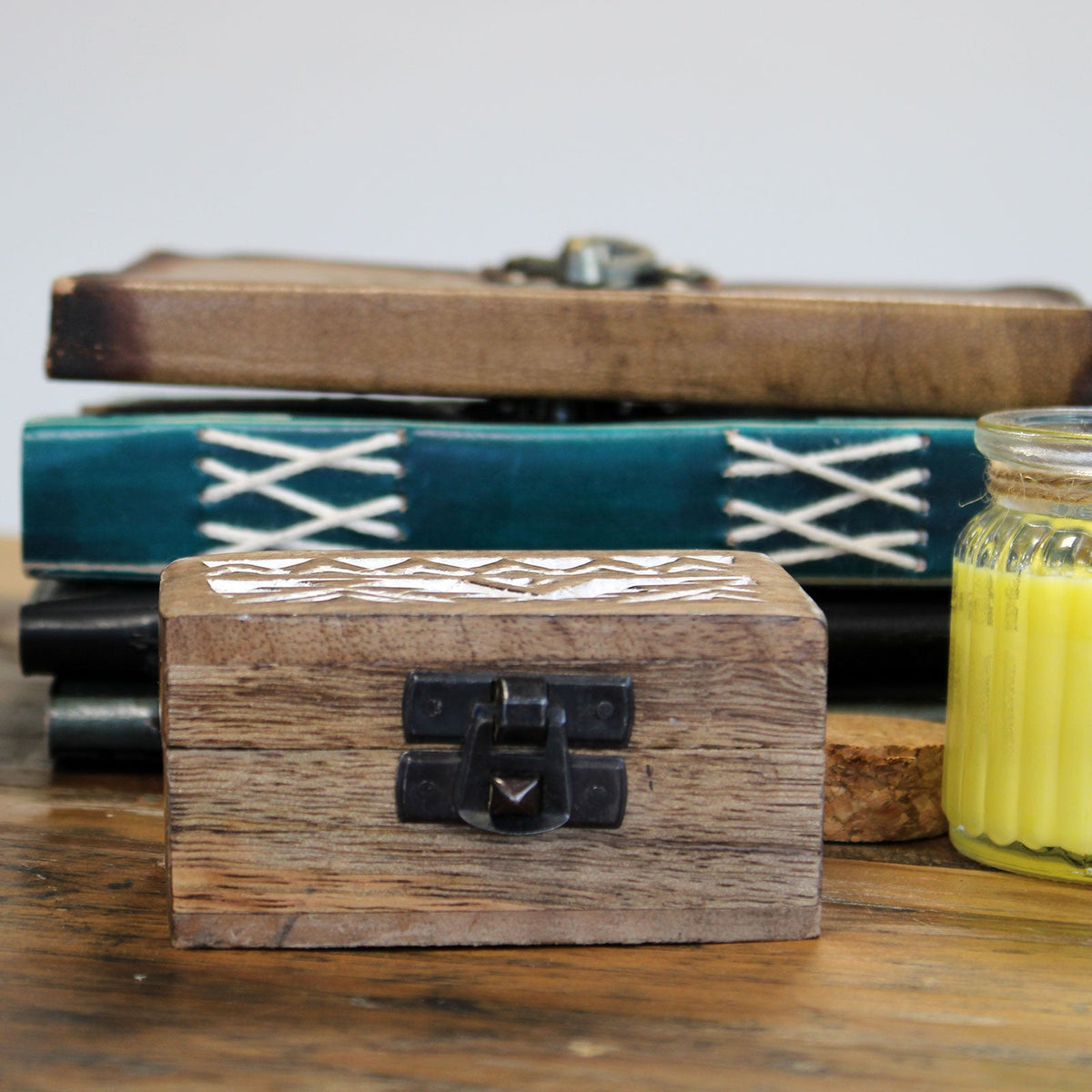 Mango Wood Keepsake Box - Small - Whitewash - Aztec Design, closed box with a white patterned lid and dark clasp in front of stacked books by Quintessential Holistic Health Ltd