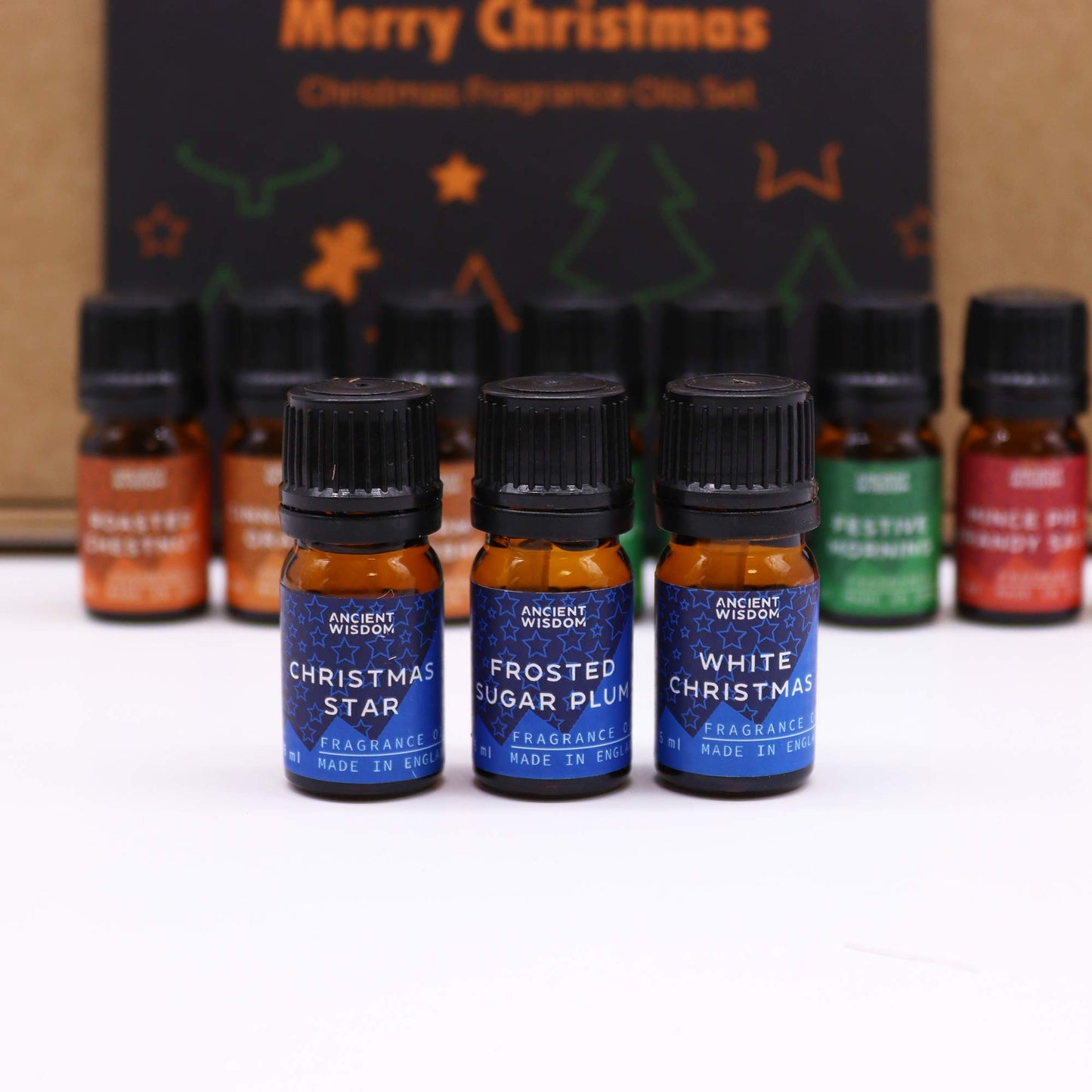 Christmas Fragrance Oil Set - Festive Delights, three blue bottles labelled Christmas Star, Frosted Sugar Plum and White Christmas by Quintessential Holistic Health Ltd